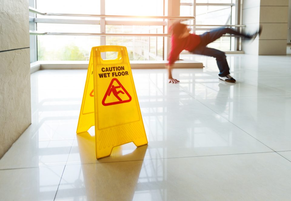 Man slips falling on wet floor